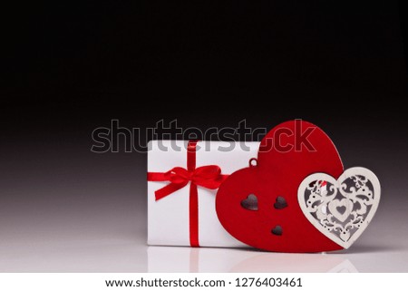 Wooden decorative hearts and gift box. Valentine's Day card with copy space. Design element for romantic greeting card, wedding invitation,