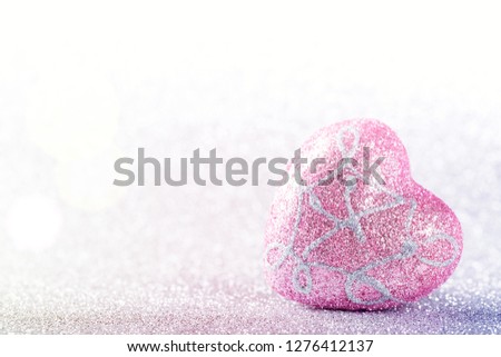 Valentines Day background. Heart shape on glitter bokeh with copyspace, nobody