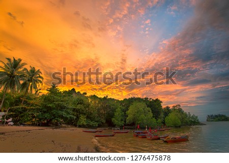 Sunset at the beach and dramatic cloud background with slow shutter speed