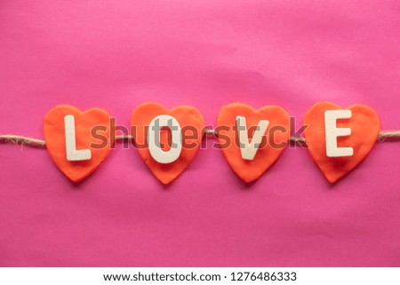 shape of heart, word LOVE in red hearts on pink background, Love icon, valentine's day, relationships concept with copy space
