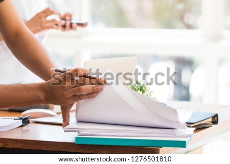 Co working team meeting concept: Asian Business people work and studying together with document notebook and papers in modern office, discuss finance /marketing solution reporting file in busy offices