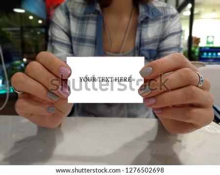 photo female hands holding paper, business card