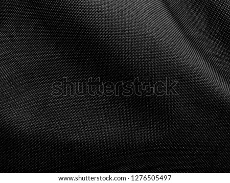beautiful luxury shadow black cloth background, detail of wavy black opaque fabric background, background of closeup crumpled textile shiny black color Royalty-Free Stock Photo #1276505497