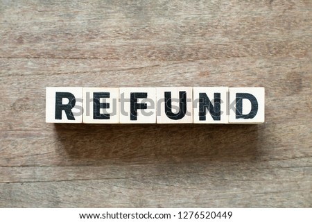 Letter block in word refund on wood background Royalty-Free Stock Photo #1276520449