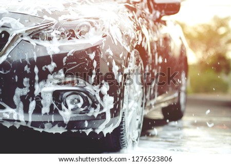 Outdoor car wash with foam soap.