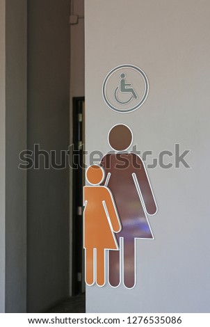 Toilet female signs on cement wall background.