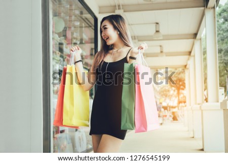 Young asian women holding shopping bag at shopping mall.