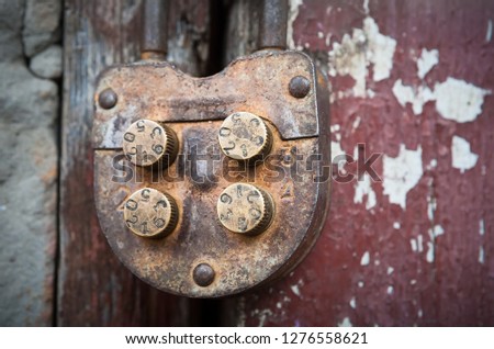 Old rural farm of peasants. On the barn hangs a lock with a code set on the numbers. Picture taken in Ukraine, Kiev region. Black and white image. Tint. Color image