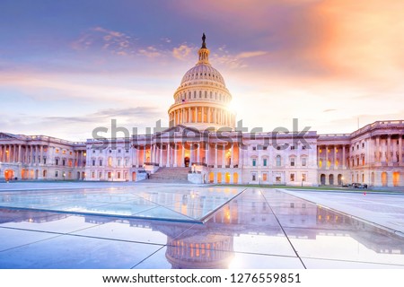 The United States Capitol building with the dome lit up at night.  Royalty-Free Stock Photo #1276559851