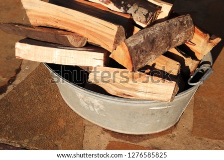 Fire wood in a steel container. Fire making concept image. 