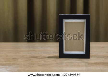 Old photo frame on wooden table