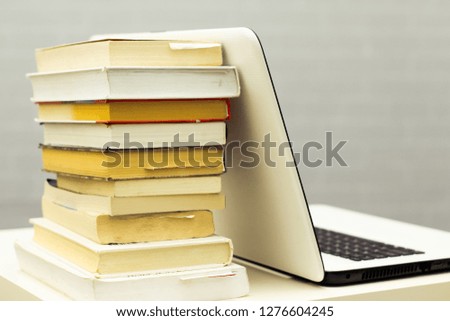 Education background with laptop and books