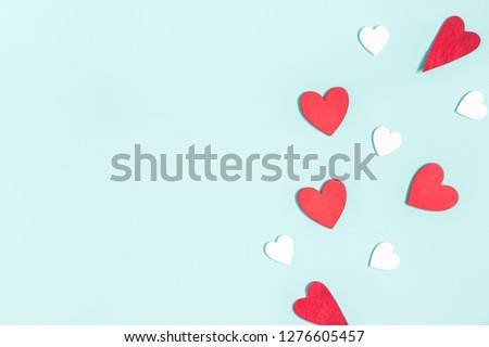 Valentine's Day background. White and red hearts on pastel blue background. Valentines day concept. Flat lay, top view, copy space Royalty-Free Stock Photo #1276605457