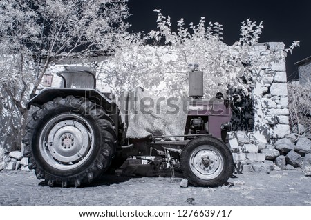 a tractor in front of old greek house 720nm infrared photo
