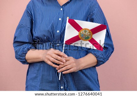 Florida state flag. Close up of hands holding Florida flag.