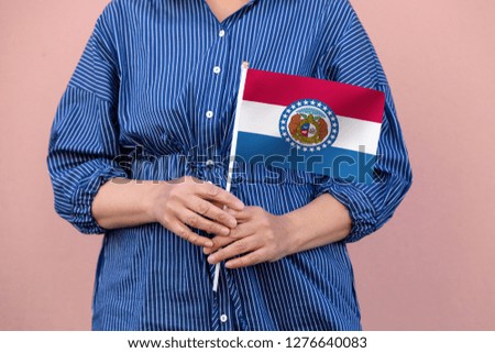 Missouri state flag. Close up of hands holding Missouri flag.