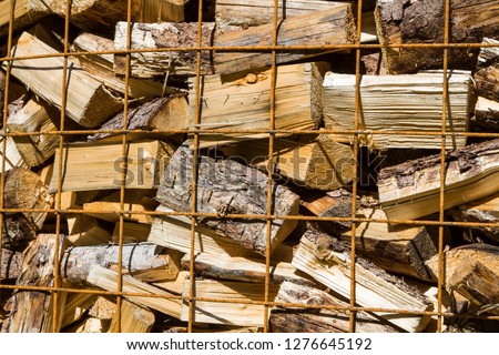 Firewood provided in metal baskets waiting for sale and removal