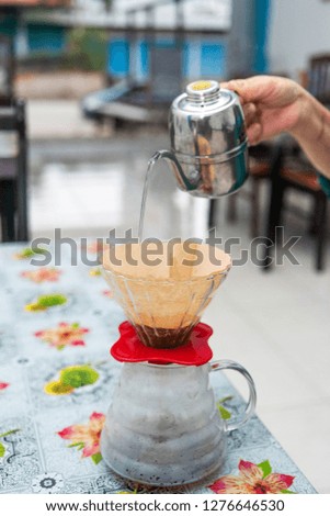 Manual coffee brewing with V60 pour over method with coffee filter