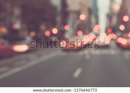 BLURRED CARS IN THE NEW YORK CITY STREET AT DUSK