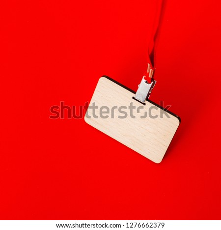 Wooden badge with lace on red background. Place for text. Close up