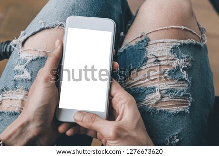 mockup image cell phone blank white screen for text.people sit enjoy relax on sofa using mobile.typing texting message chatting with friend.concept for modern communication in the business financial 