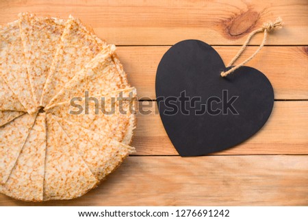 Top view of crepes (french pancakes), blank heart with copy space, rustic wood background