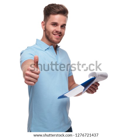 casual man wearing polo shirt checks files and makes ok sign while standing on white background, portrait picture
