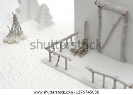 Photographs of small handmade winter objects with white felt and bleached wood, depicting a miniature snowy village, ideal for Christmas, New Year and Epiphany cards