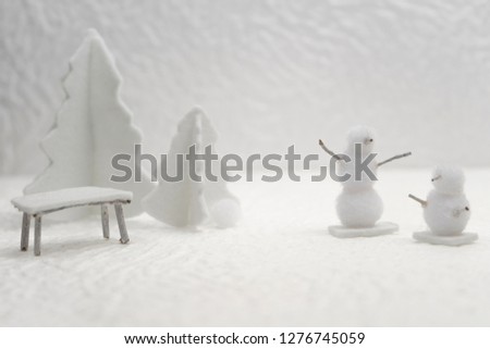 Photographs of small handmade winter objects with white felt and bleached wood, depicting a miniature snowy village, ideal for Christmas, New Year and Epiphany cards