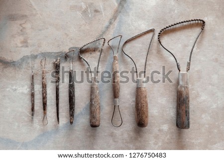 Sculpture tools. Art and craft tools on vintage wood background. Close-up image.