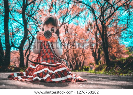 Little girl  with cherry blossoms tree background
