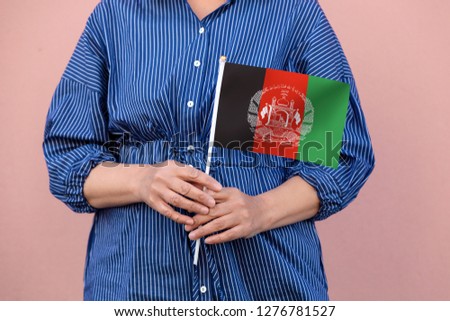 Afghanistan flag. Close up of hands holding national flag of Afghanistan.