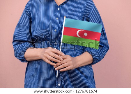 Azerbaijan flag. Close up of hands holding national flag of Azerbaijan.