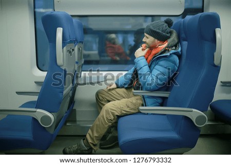 man sits by the window in the train / concept of transport people, passengers, seats in the subway train