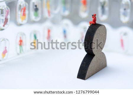 Miniature people, recruiters on wooden people sign for finding the candidates on the wall. Human resource concept, recruiting, hiring process.