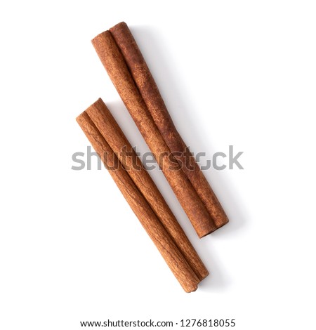 Cinnamon sticks isolated on white background closeup. Canella spice. Aromatic condiment background. Flat lay, top view. Royalty-Free Stock Photo #1276818055