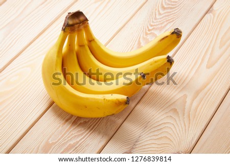 Image of Banana cluster on wooden table