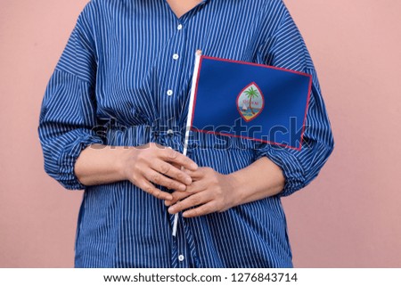 Guam flag. Close up picture of hands holding national flag of Guam.