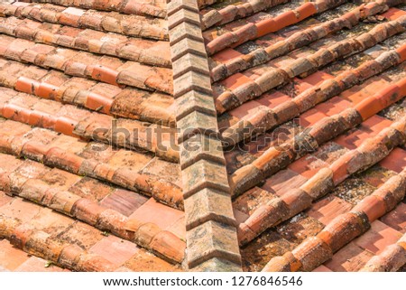 Ceramic orange clay tiles on the roof of a building, corner