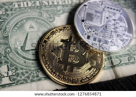 Close up view of gold and silver bitcoin with different background