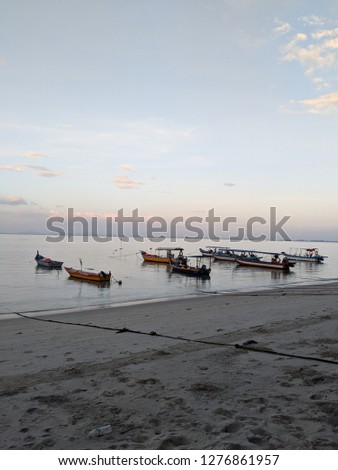 sunset on a fishermen village in south east asia with boats fishing boats by the shore