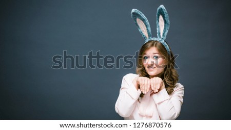 Festive bunny and eggs season. happy modern woman in Easter bunny ears isolated on grey background