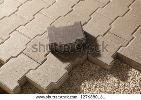 Building an pedestrian path with paver bricks. Sidewalk pavement