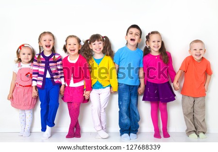 Big  group of diverse children  at  white wall