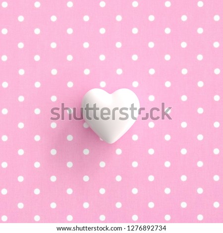 White Heart On pokadot pink background. minimal valentine concept idea.