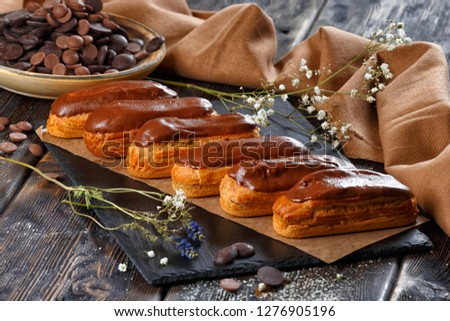 Traditional french eclairs with chocolate. Royalty-Free Stock Photo #1276905196
