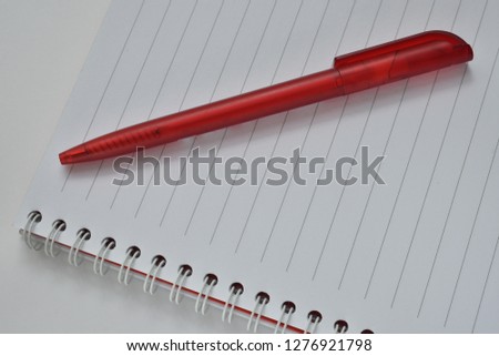 red pen on a notebook