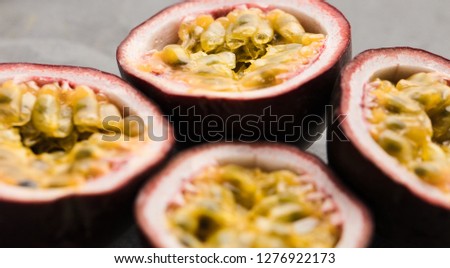 Ripe organic passion fruit on dark background. above view