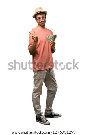 Man holding many bills happy and counting two with fingers on isolated white background