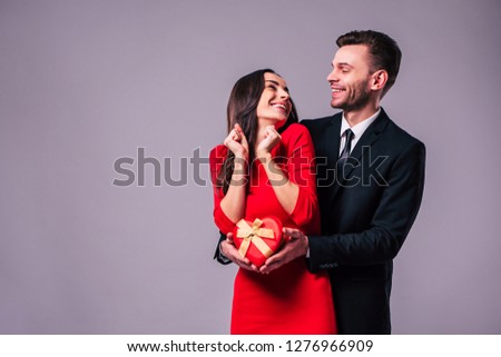 Excited and happy couple in love are hugging, kissing and celebrating the St Valentines day. Celebration, holidays and gifts concepts. St Valentines dat. Lovers day